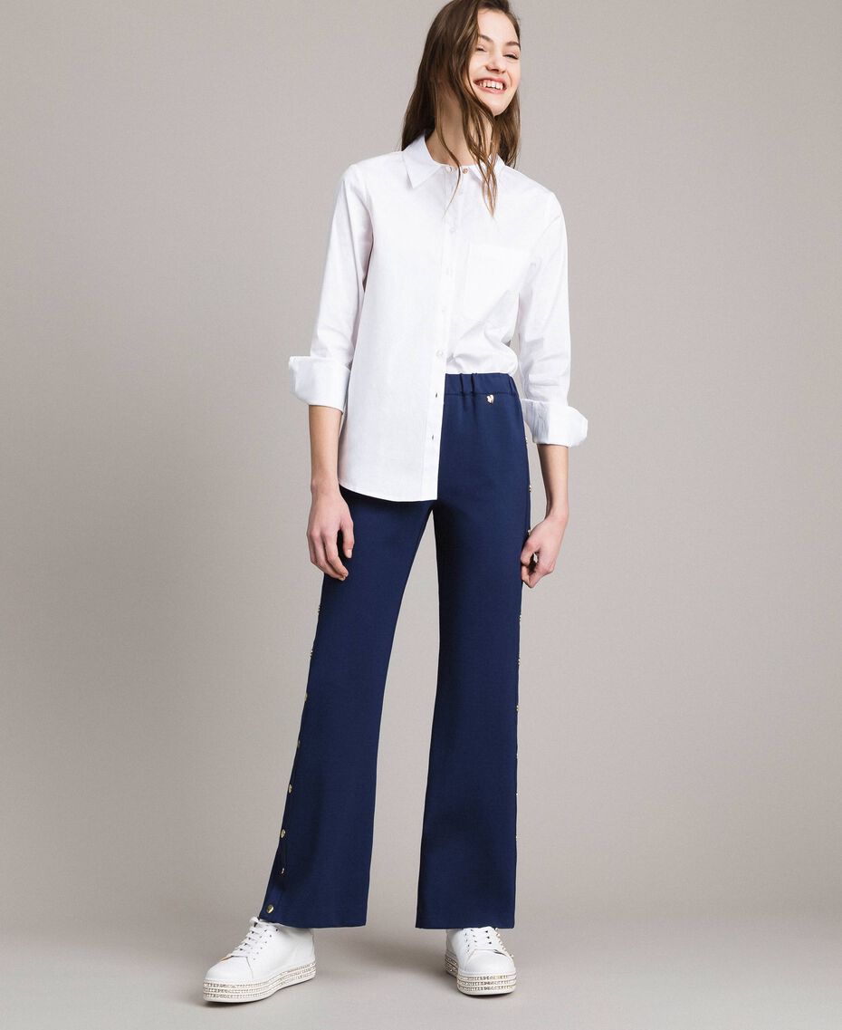 Drainpipe trousers with side slits and buttons