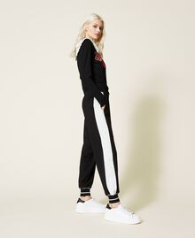 Pantalon de jogging avec bandes latérales Bicolore Noir / Blanc Neige Femme 221LL26QQ-01
