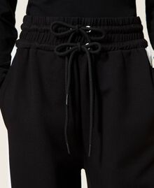 Pantalon de jogging avec bandes latérales Bicolore Noir / Blanc Neige Femme 221LL26QQ-04