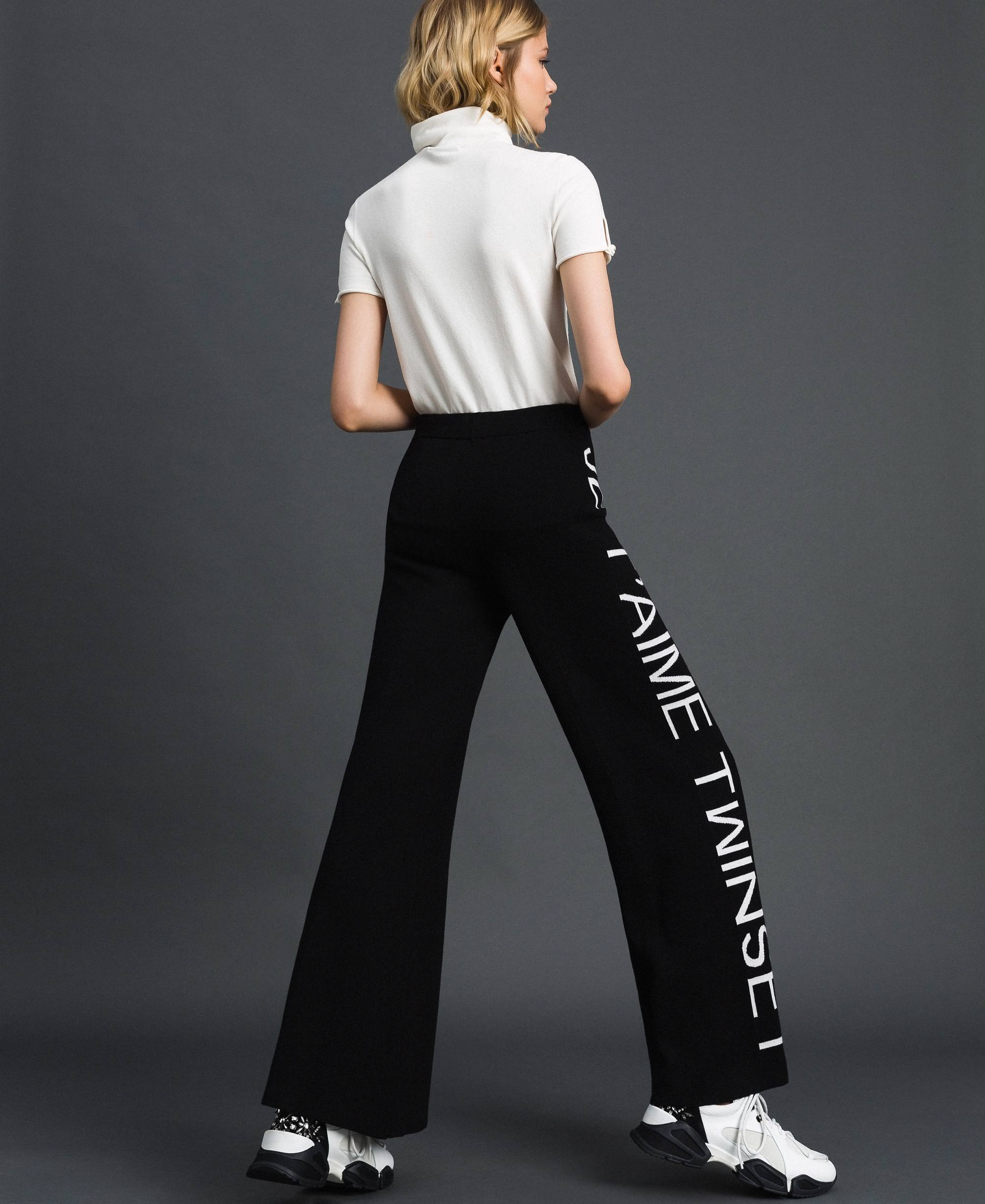 Pantaloni a palazzo in maglia con logo
